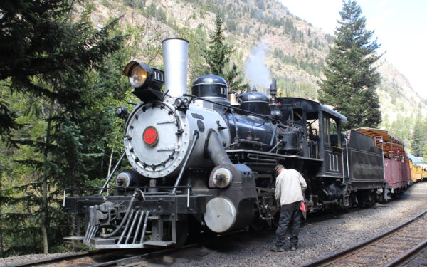 Man Looking at Steam Locomotive