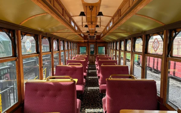 Interior of Georgetown Loop Tahoe parlor car featuring burgundy upholstered seats and elegant wood