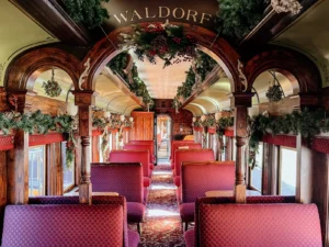 Georgetown Loop Waldorf car interior showcasing elegant arched woodwork and holiday decorations
