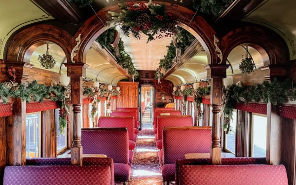 Georgetown Loop Waldorf car interior showcasing elegant arched woodwork and holiday decorations