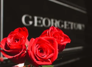 Bouquet of vibrant red roses in the foreground with Georgetown Loop Railroad locomotive lettering