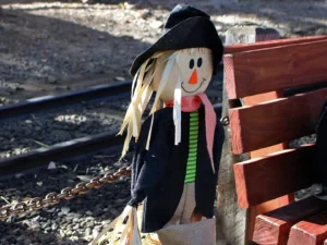 Friendly scarecrow decoration by railroad tracks at Georgetown Loop Pumpkinfest fall event