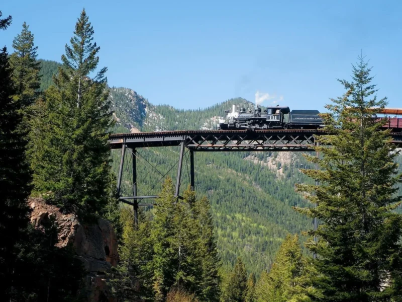 Historic steam locomotive crossing the iconic Devil's Gate High Bridge on Georgetown Loop Railroad