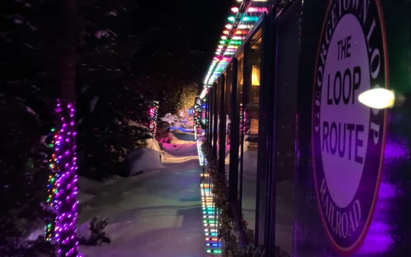 Georgetown Loop Railroad Winter Holiday Train decorated with colorful Christmas lights traveling