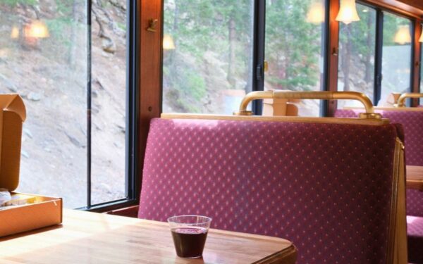 Glass of wine on table in train car seating booth