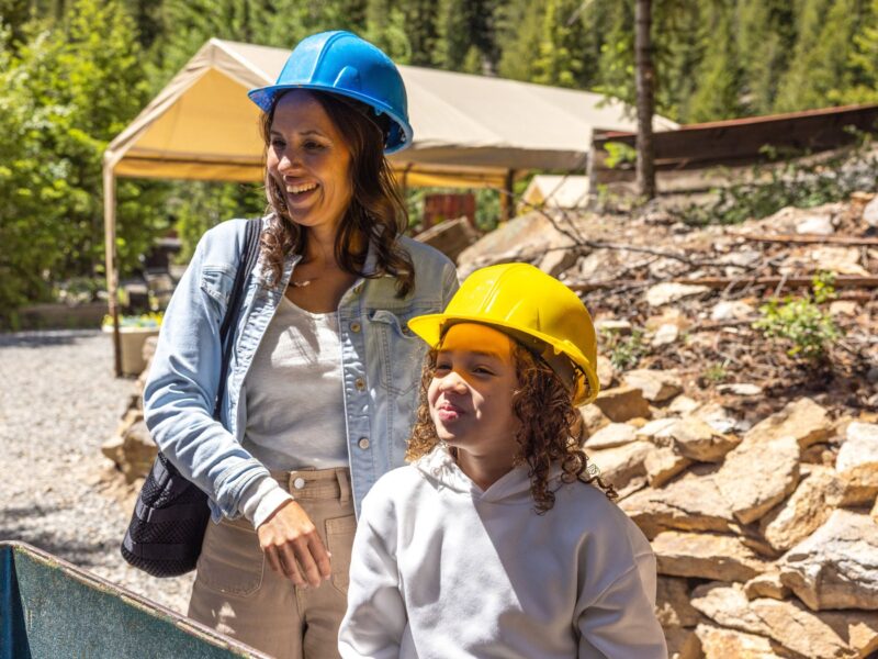 Two people wearing hard hats in an outdoor setting